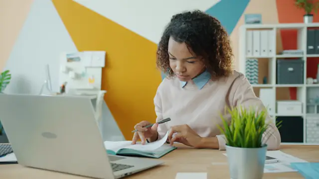 A jobseeker reading a job advert carefully and taking notes
